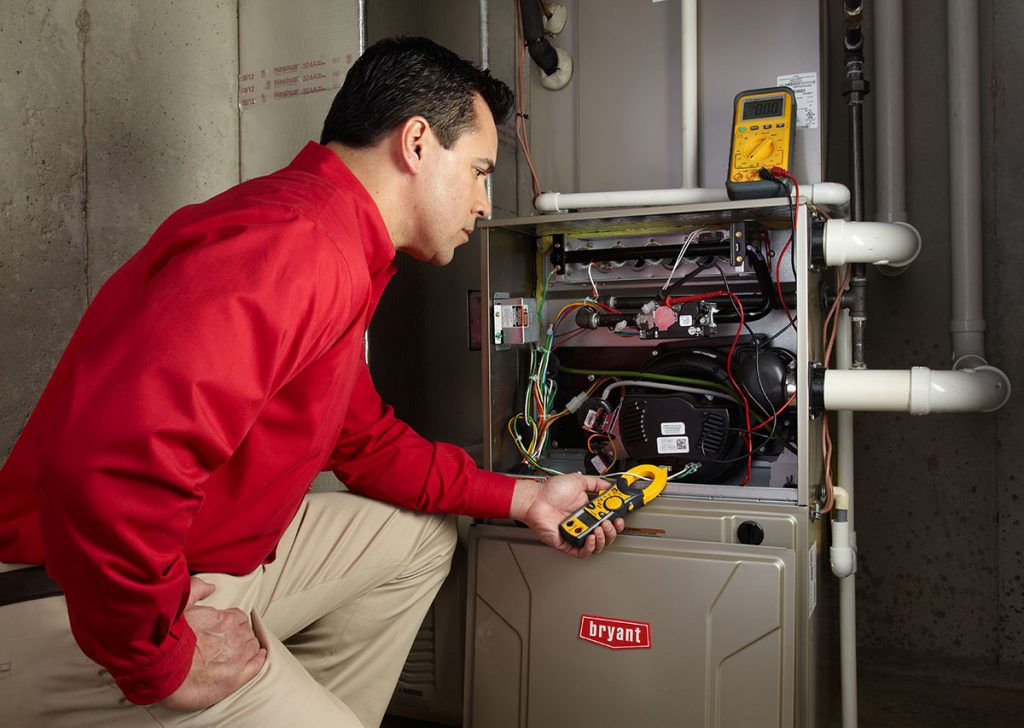 HVAC technician repairing an indoor furnace in Lafayette
