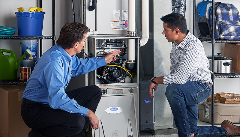 HVAC technician evaluating a furnace for repair or replacement in Lafayette