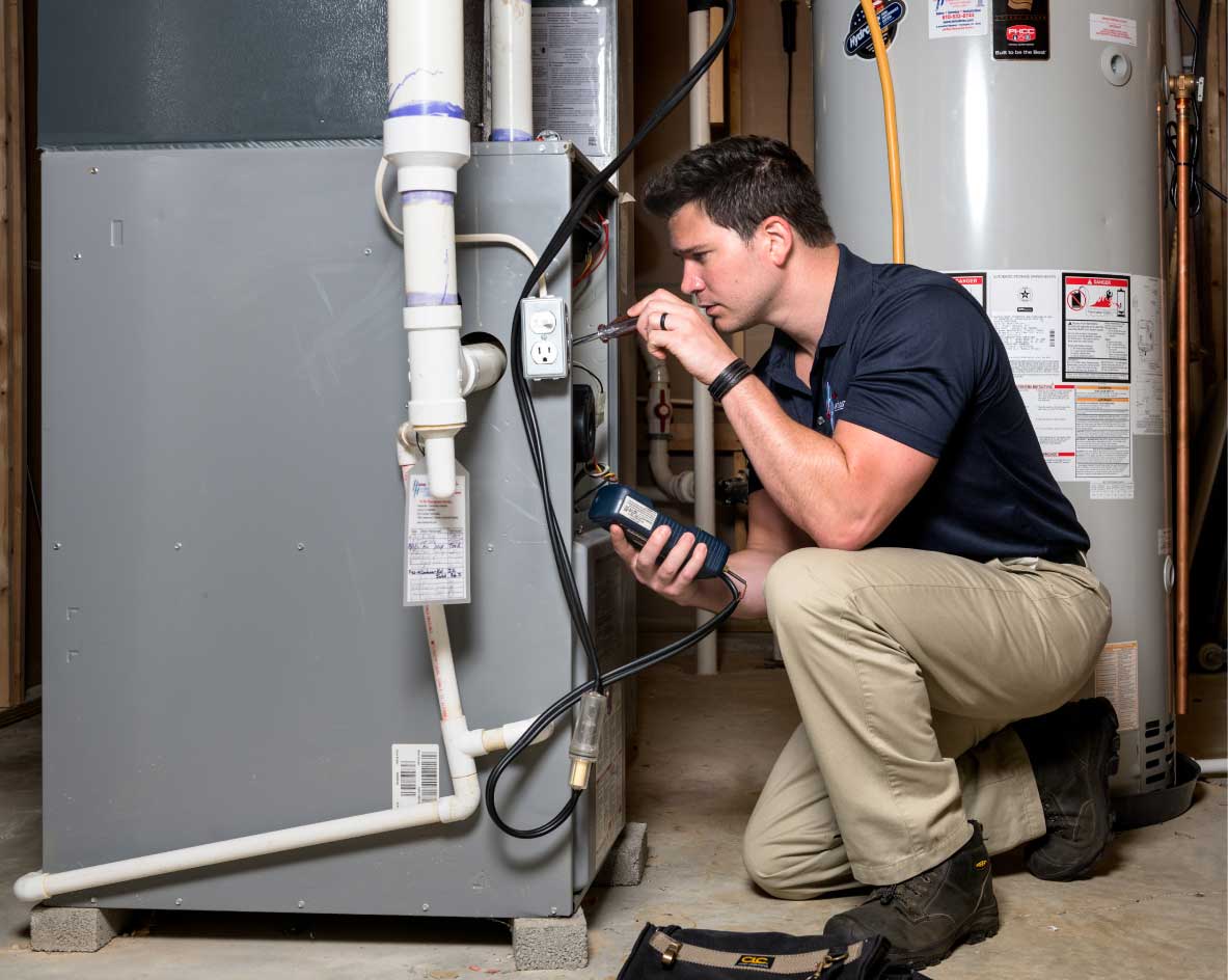 HVAC technician performing a furnace tune-up in Lafayette