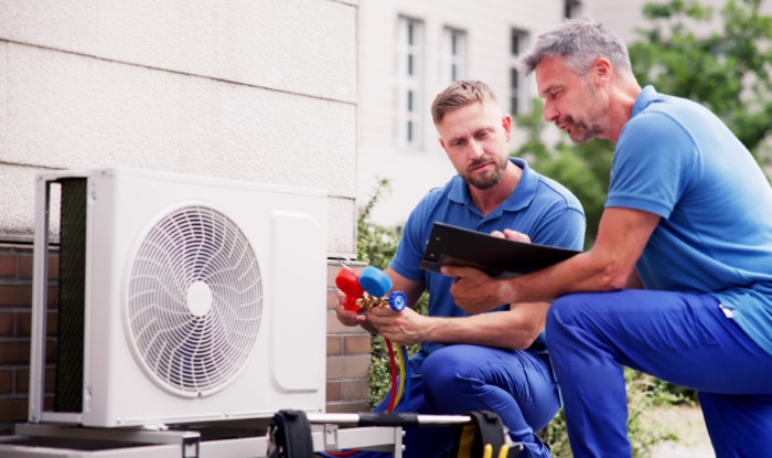 HVAC technicians installing an outdoor air conditioning unit in Lafayette