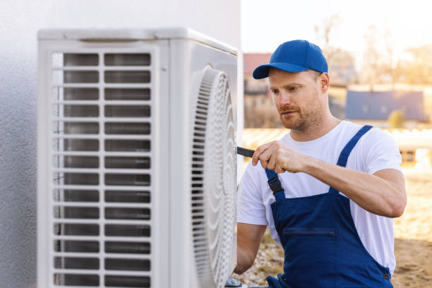 HVAC technician servicing an outdoor air conditioning unit in Lafayette