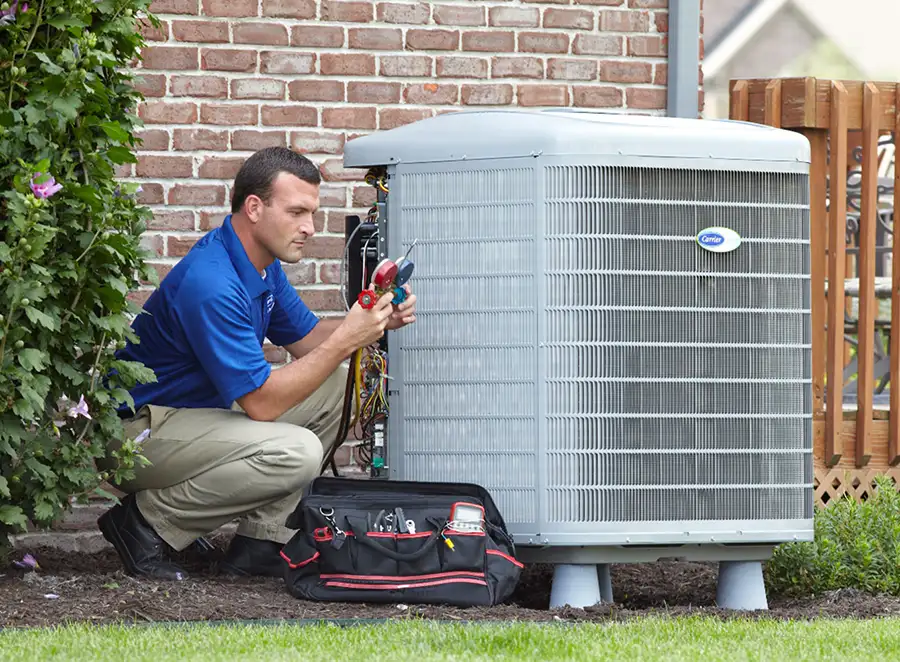 HVAC technician inspecting an outdoor air conditioning unit in Lafayette