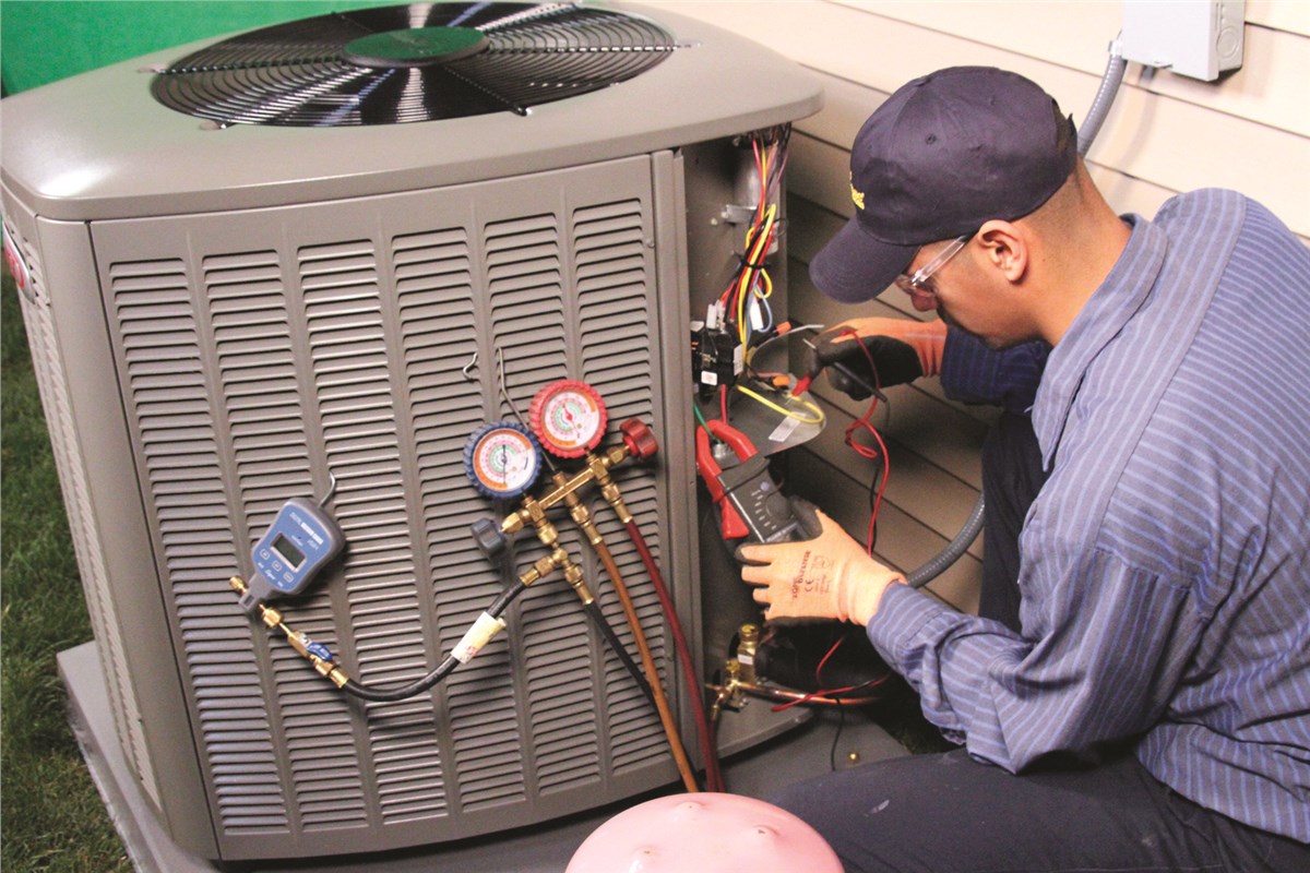 HVAC technician testing an outdoor air conditioning unit in Lafayette